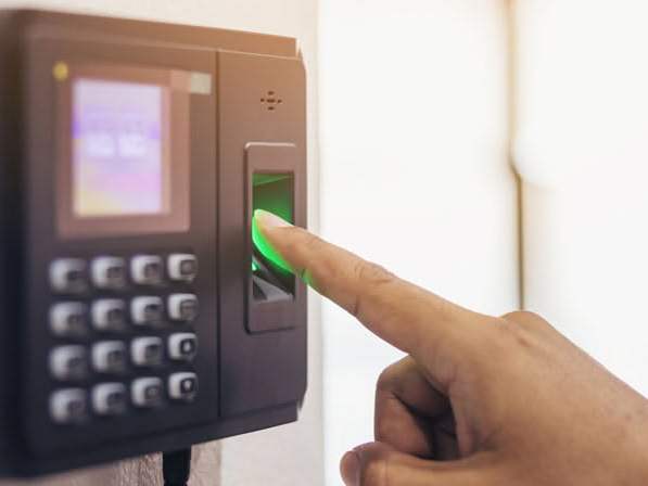 A finger on the fingerprint reader of an access control terminal