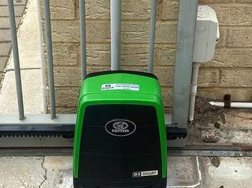 A sliding gate motor installed at the base of a gate