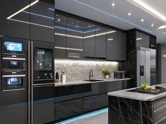 A dark modern kitchen with built-in ovens and strip lighting